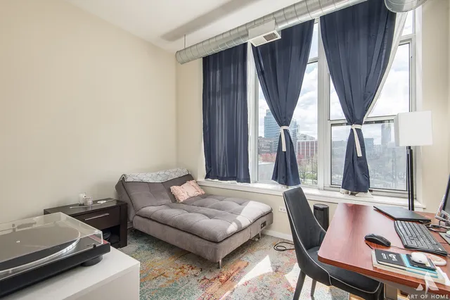 a bedroom with furniture and a window