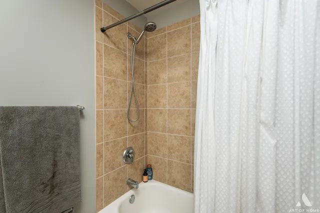 a bathroom with a shower and a sink