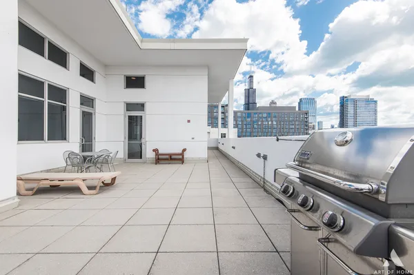 a view of roof deck with seating space and barbeque oven