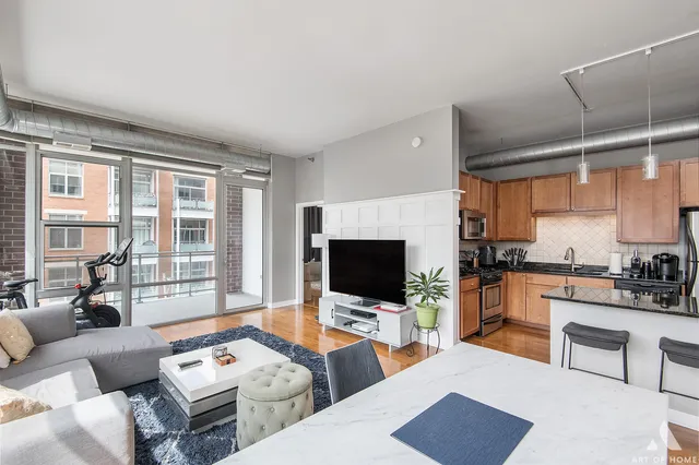 a living room with furniture a flat screen tv and a fireplace