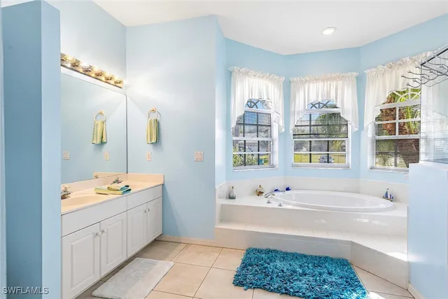 a bedroom with a bed a lamp and a dresser