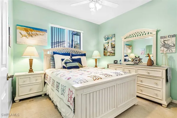 a bedroom with bed and a book shelf