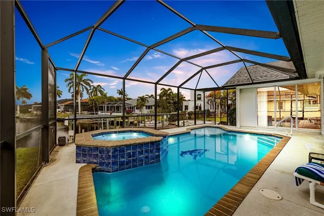 a swimming pool with outdoor seating and yard
