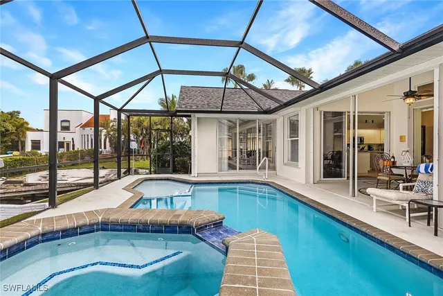 a view of a lake with couches in the patio