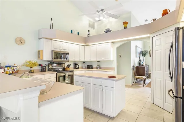 a dining room with furniture and a floor to ceiling window