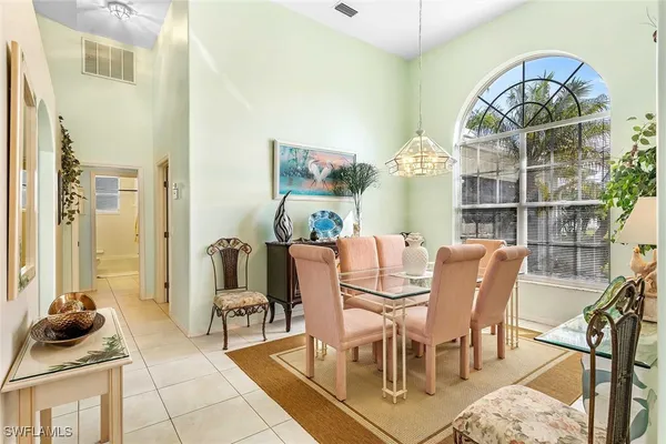 a living room with furniture a chandelier and a rug