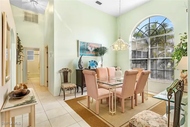 a living room with furniture a chandelier and a rug