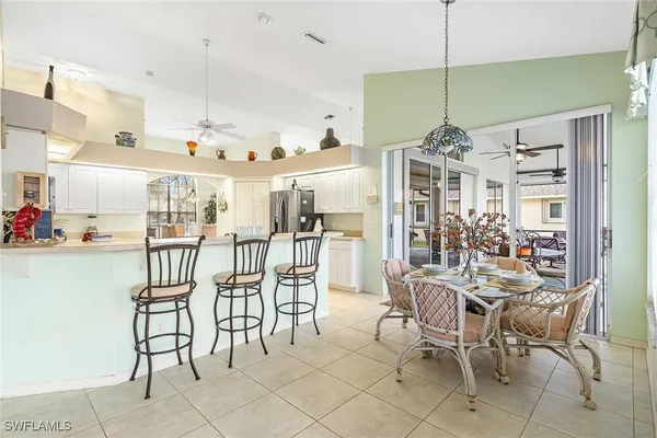 a bedroom with a bed couch and large windows