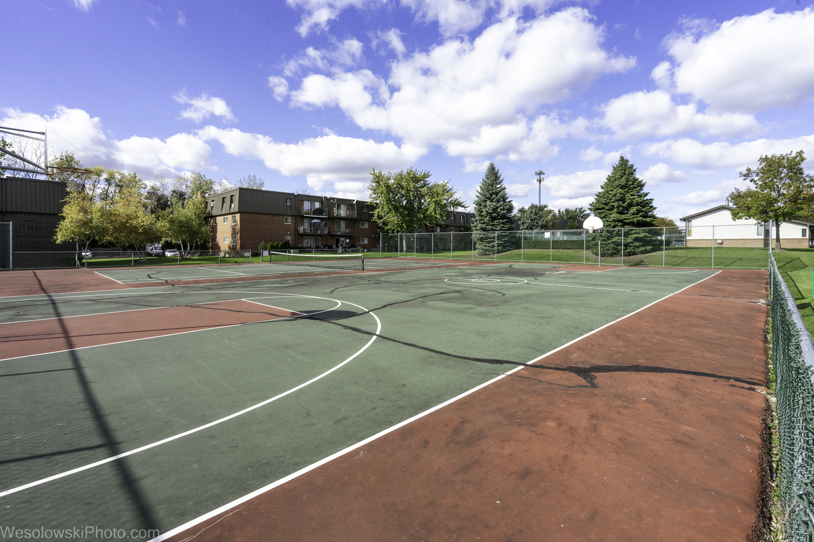 577 Fairway View Drive, Unit 1J Wheeling, IL 60090 - Photo 20 of 26 a view of a tennis ground with large trees