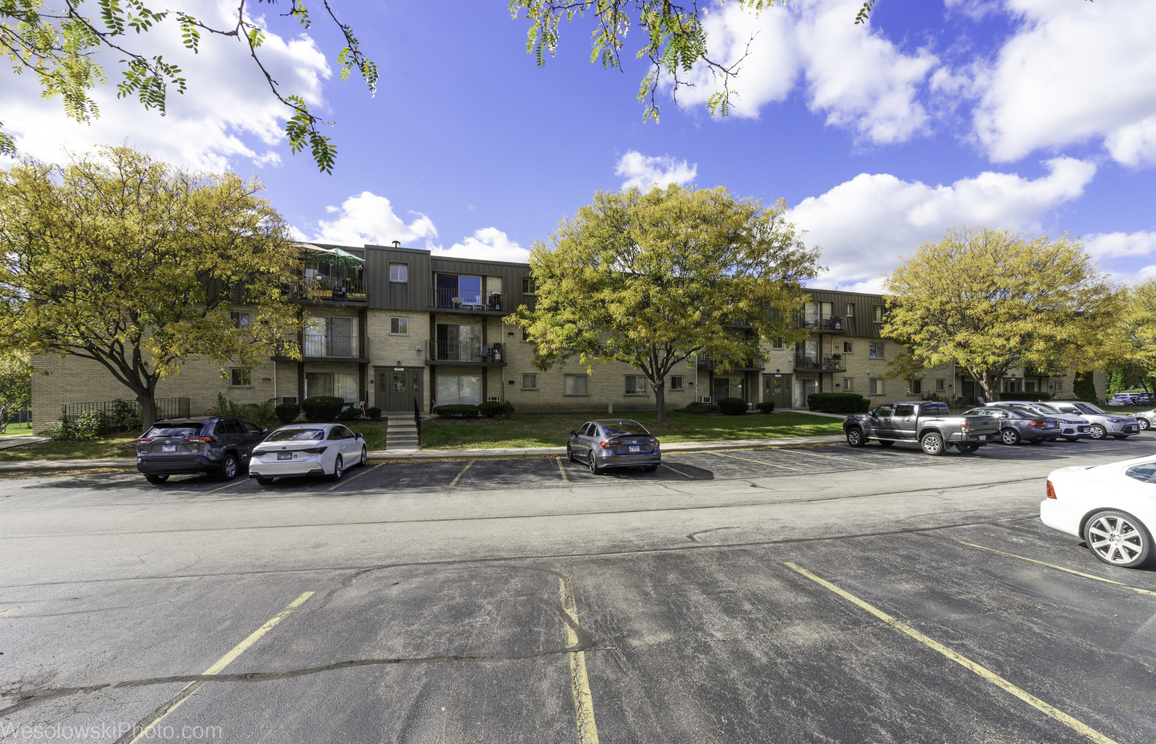 577 Fairway View Drive, Unit 1J Wheeling, IL 60090 - Photo 22 of 26 a view of a street with a cars parked in front of it
