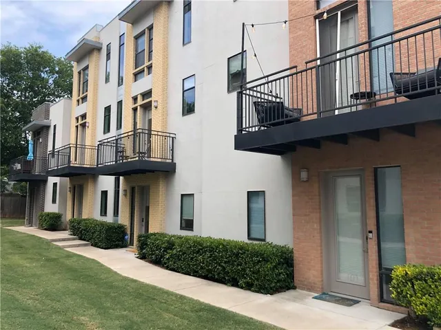 a view of building with yard and staircase
