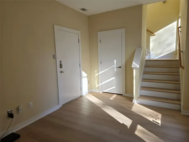 a view of a livingroom with wooden floor and window