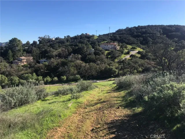a front view of a house with cars parked