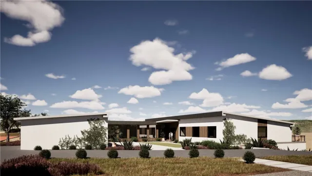 a front view of a house with lots of cars parked