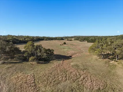 a view of wooden fence and trees around