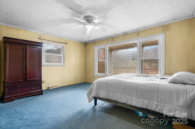 a bedroom with a bed and window