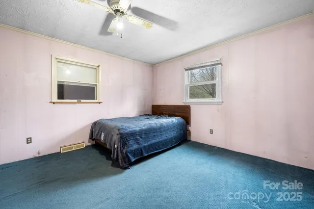 a bedroom with a bed and a chandelier
