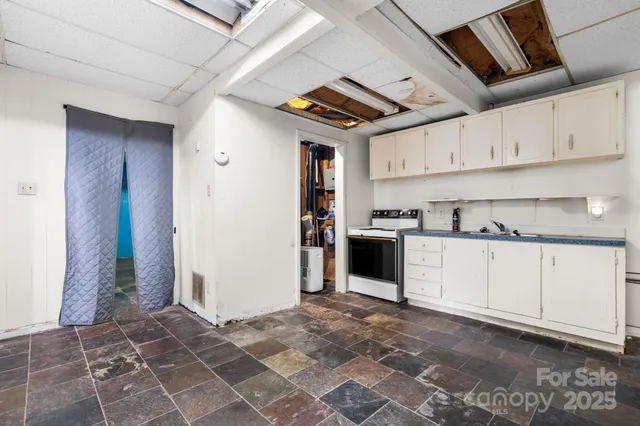 a kitchen with stainless steel appliances granite countertop a refrigerator and a stove
