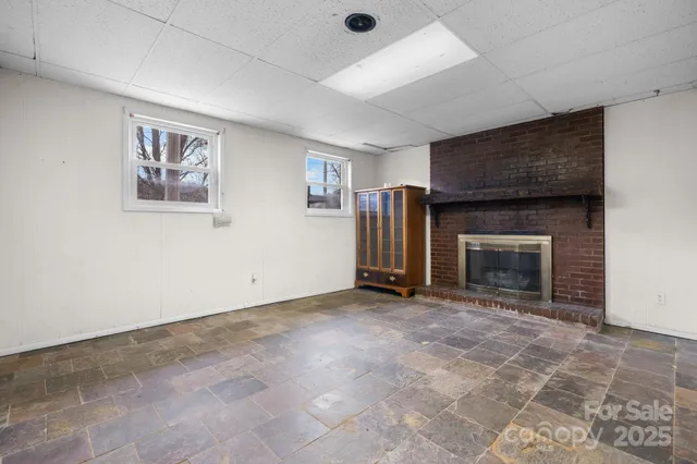 an empty room with furniture and a fireplace
