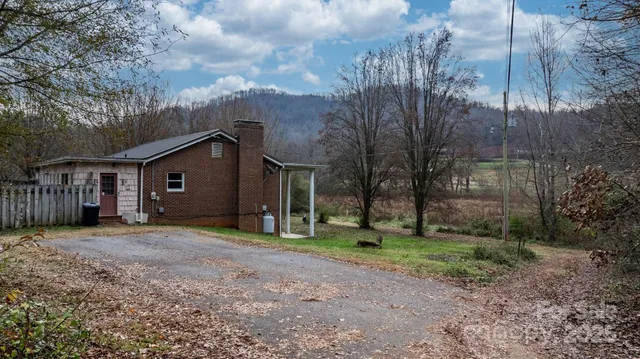a view of a house with a backyard