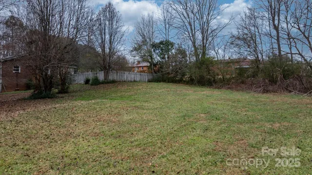a view of a field with trees in the background