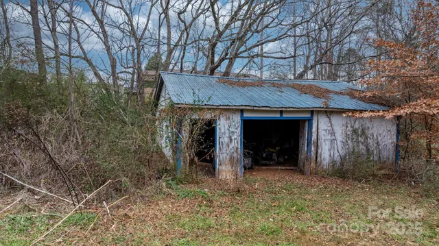 a view of a house with a yard and tree