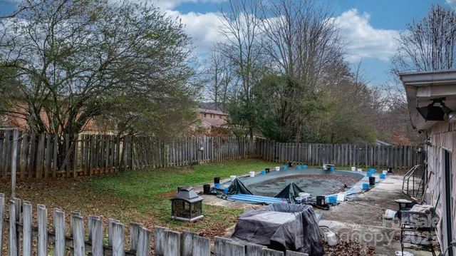 a view of backyard with table and chairs and a fire pit
