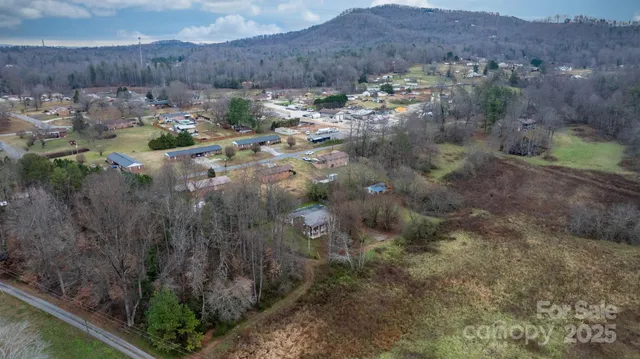 a view of a house with a yard and lake view