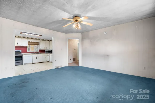 a view of a kitchen with a sink and a ceiling fan