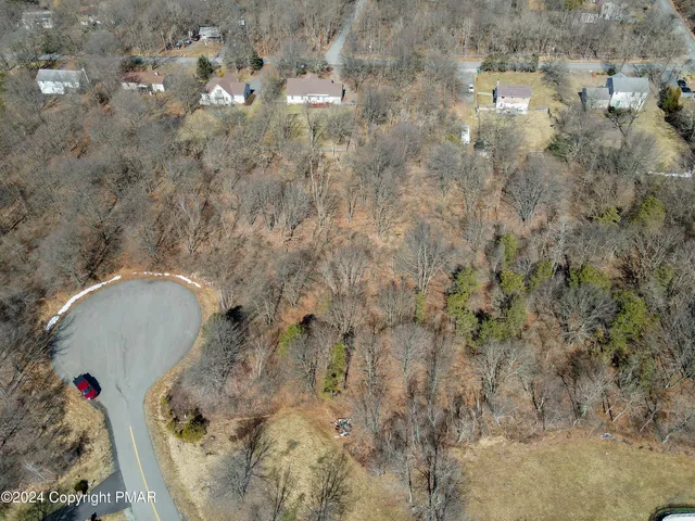 a aerial view of houses with yard