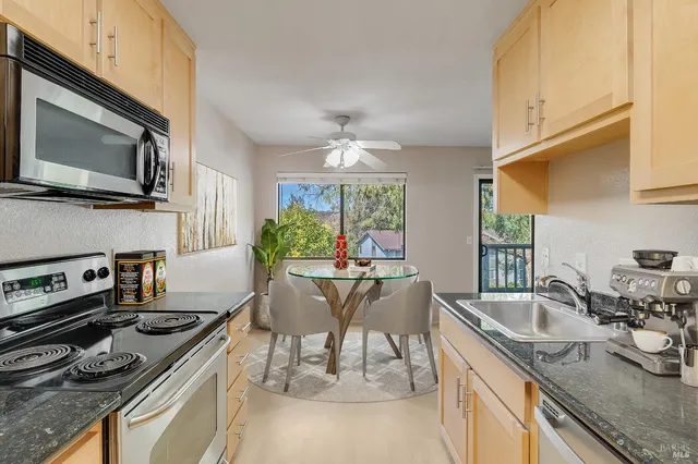 a kitchen with a stove a sink and a microwave