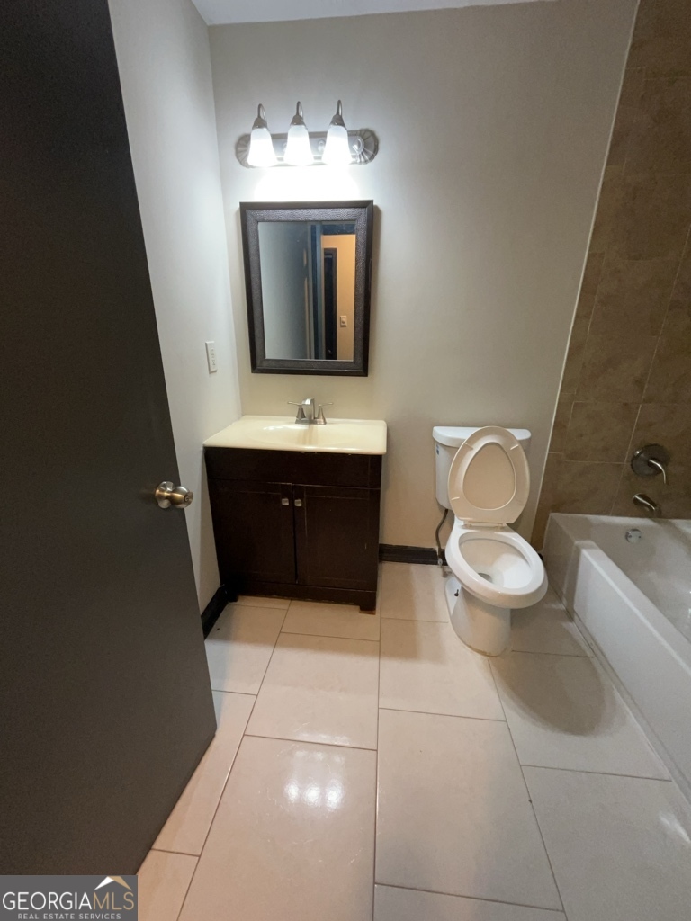 1265 Herrington Road Lawrenceville, GA 30044 - Photo 33 of 52 a bathroom with a toilet sink and mirror