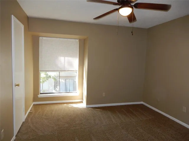 a white toilet and tub sitting next to a bathroom sink