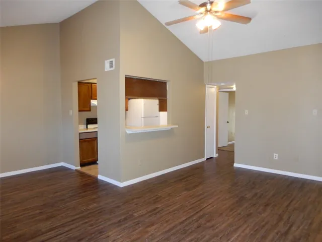 a view of an empty room with wooden floor