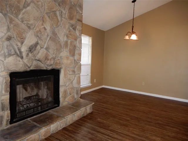 a view of a room with wooden floor and windows