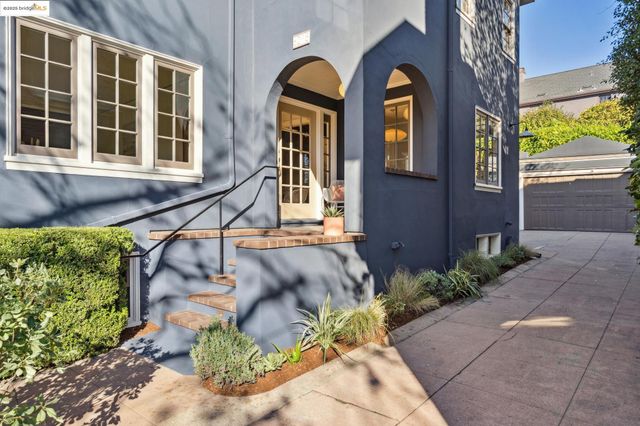 a view of a living room with a large window and wooden floor