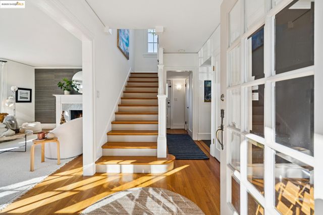 a living room with a fireplace and a potted plant
