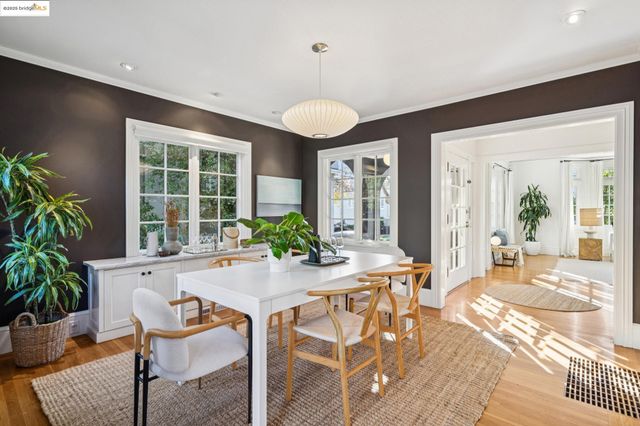 a view of a patio with table and chairs potted plants and a palm tree