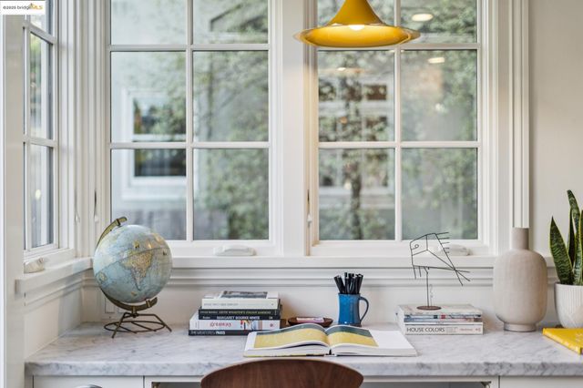 a kitchen that has a lot of cabinets in it and wooden floors