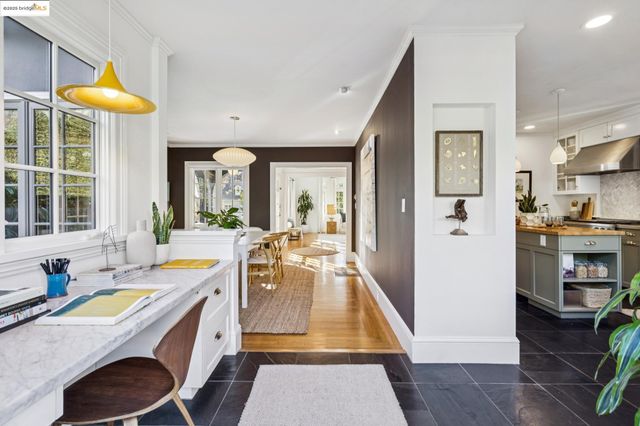 a kitchen with a stove a cabinets and chairs