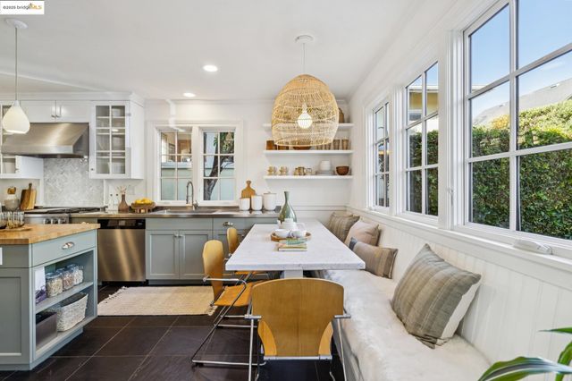 a kitchen with a table chairs sink and cabinets