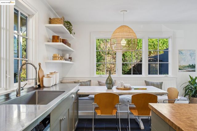 a vase of flowers sitting on a table with window