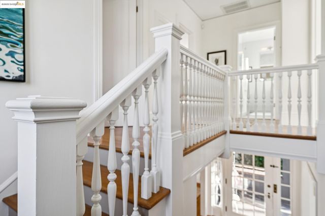 a bedroom with bed and wooden floor
