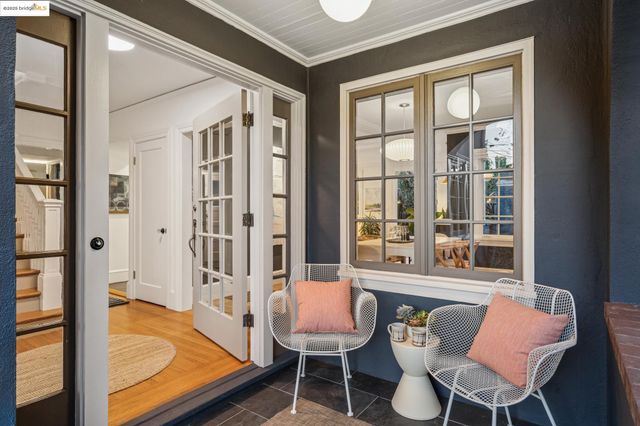 a view of a patio with table and chairs with wooden floor and fence