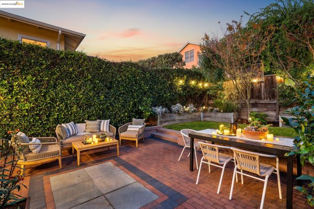 a view of an outside dining space with a table and chairs