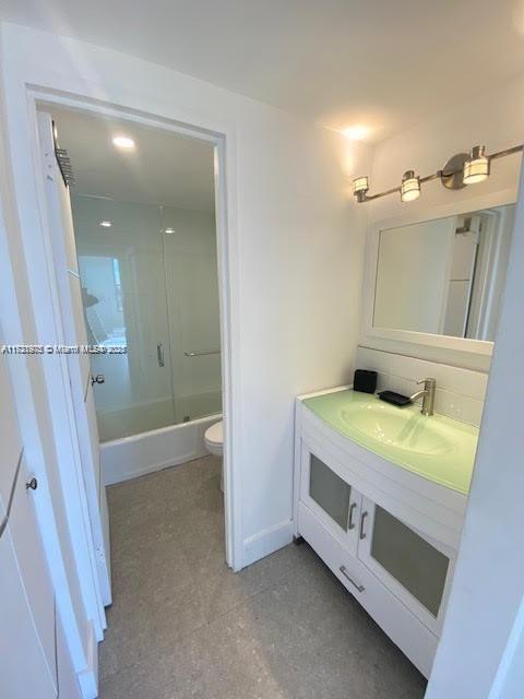 2899 Collins Avenue, Unit 548 Miami Beach, FL 33140 - Photo 11 of 22 a bathroom with a sink a toilet and shower