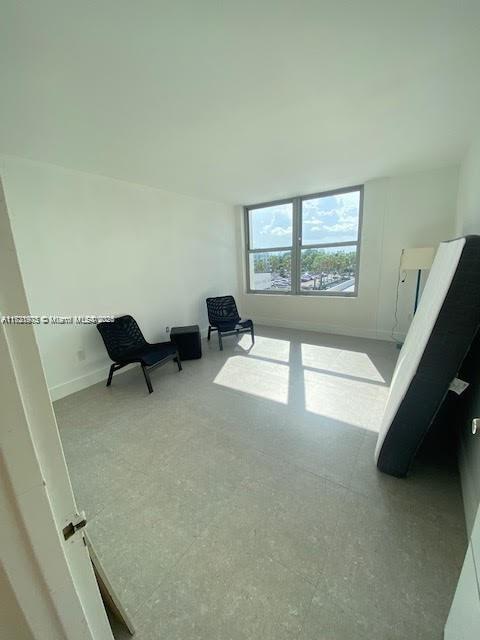 2899 Collins Avenue, Unit 548 Miami Beach, FL 33140 - Photo 13 of 22 a living room with furniture and a large window