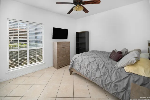 a bathroom with a granite countertop bathtub sink vanity mirror and toilet