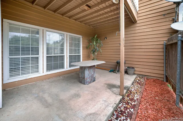 a view of a house with wooden fence
