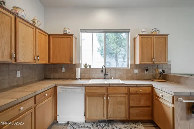 a kitchen with sink cabinets and a granite counter top